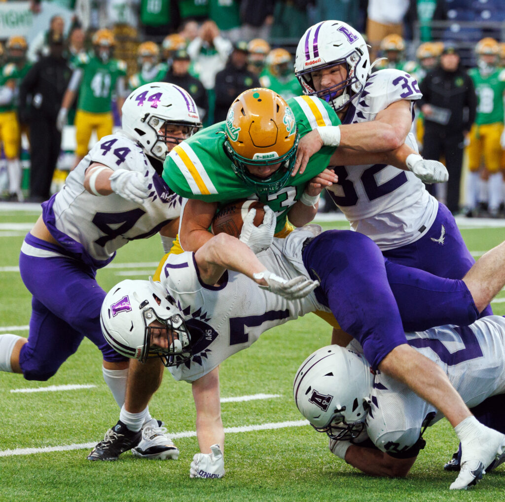 Anacortes defenders keep a Tumwater running back from entering the end zone.