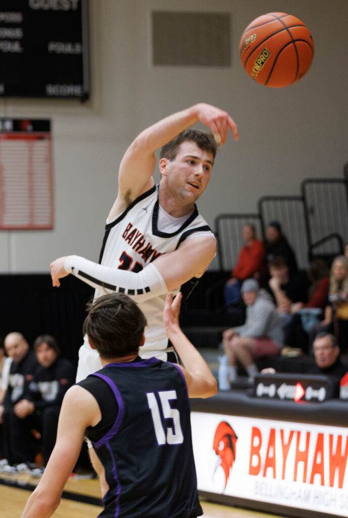 Bellingham’s Harmon Wienkers leaps and makes a pass against Anacortes.