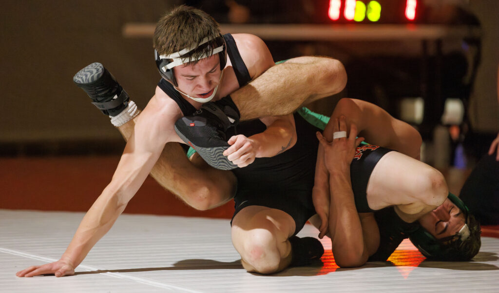 Mount Baker's Shaun Dugger holds onto the foot of Lynden's Ryuu Robeson during a double dual with Lynden, Mount Vernon, Mount Baker and Bellingham on Wednesday.