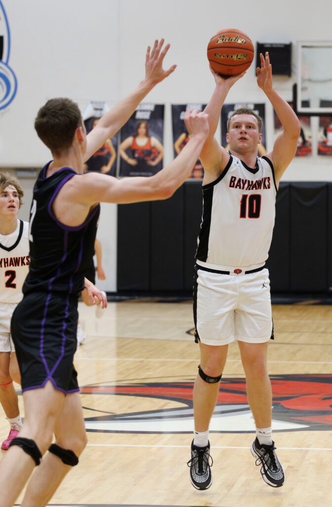 Bellingham’s Gabriel Van Hofwagen throws up a three-point shot against Anacortes Dec. 19.