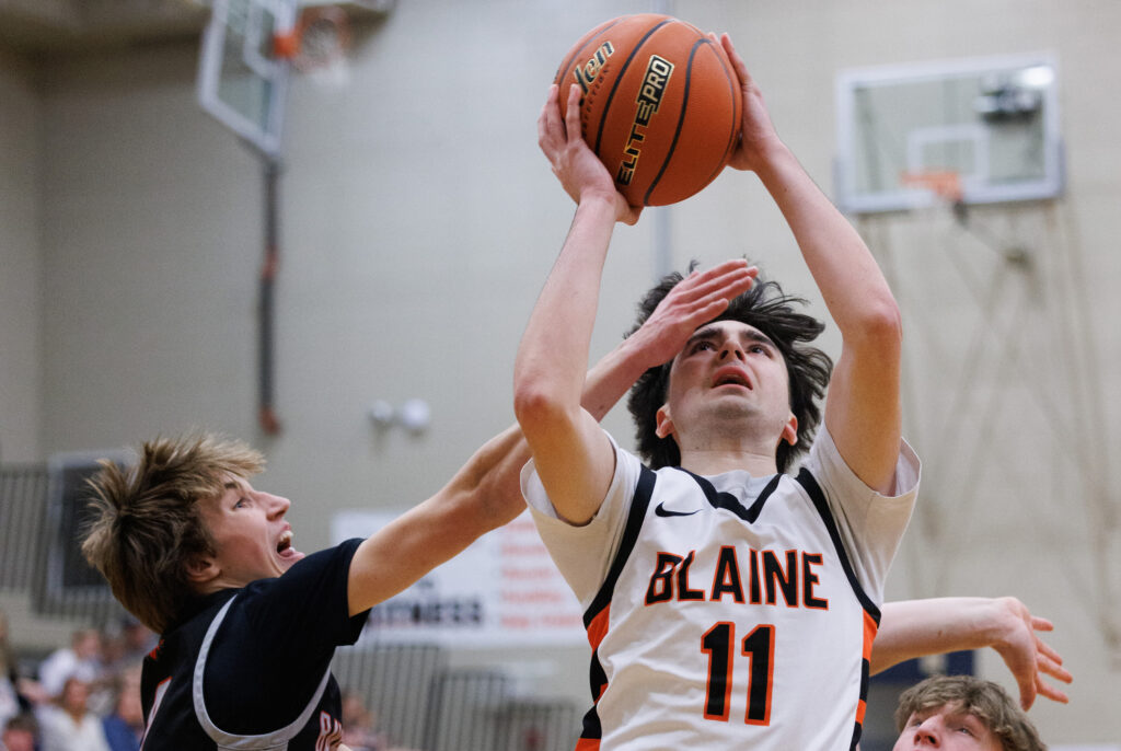 Bellingham’s Myllo Wright gets a hand in the face of Blaine’s Landon Melton.