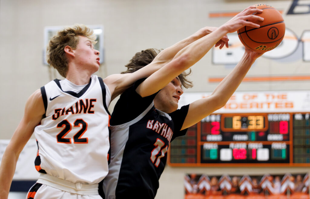 Bellingham’s Kincade Vanhouten hauls in a rebound as Blaine’s Josiah Weeda reaches for the ball.