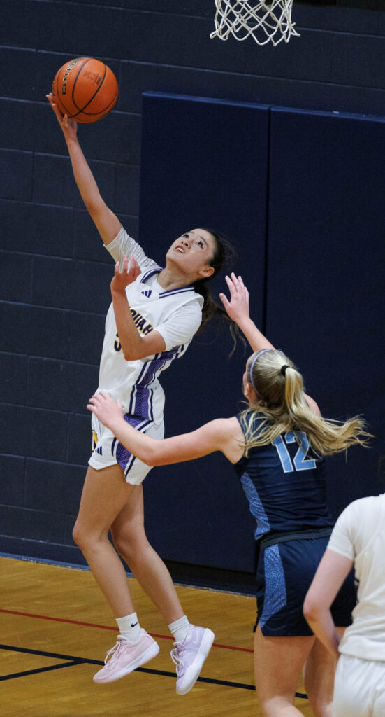 Issaquah's Henna Hung turns and scores under the basket.