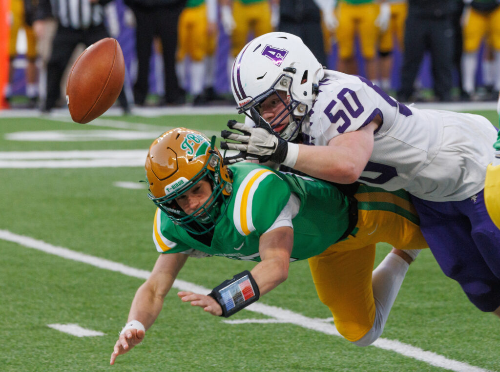 Anacortes senior Makhi Kilgore tackles the Tumwater quarterback and causes a fumble.