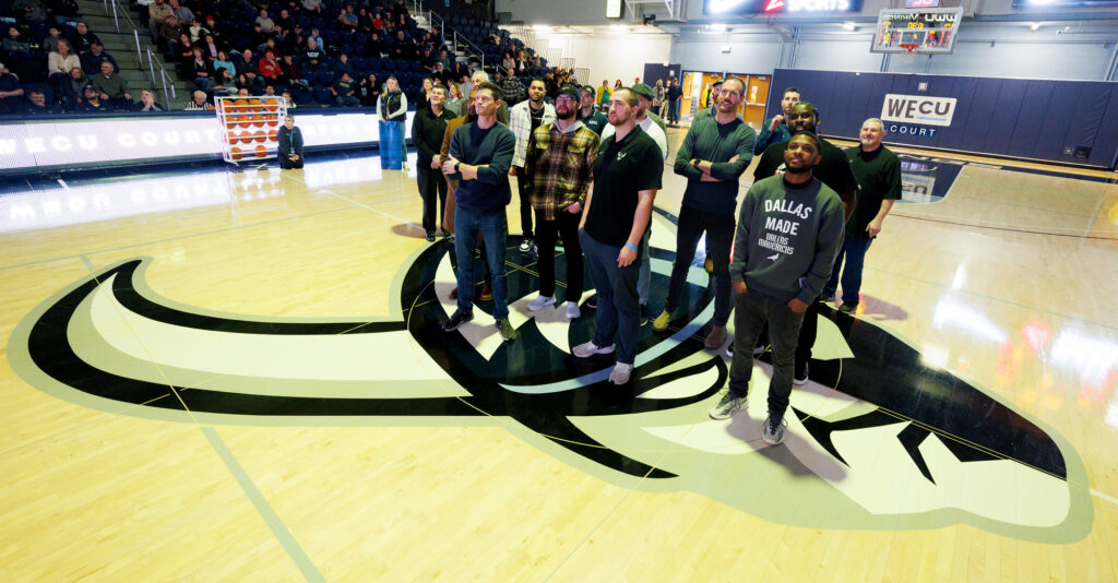 Members of Western's 2012 men’s basketball national championship team watch a highlight reel during halftime Jan. 4, 2025, after being inducted into the Western Athletics Hall of Fame. The squad is one of 13 teams being inducted in Western’s “Year of the Viking” celebration.