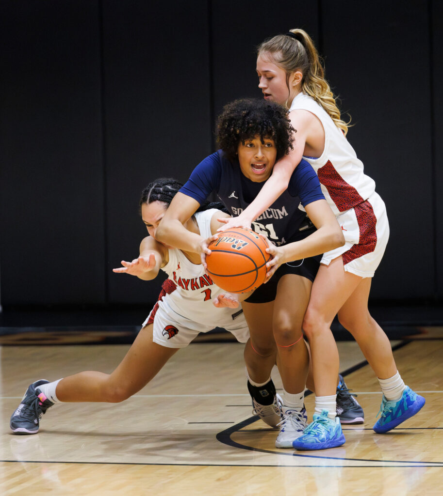 Squalicum’s Kailana Perez tries to make pass under pressure from Bellingham’s Lilyauna Jude and Jennifer Ruano.