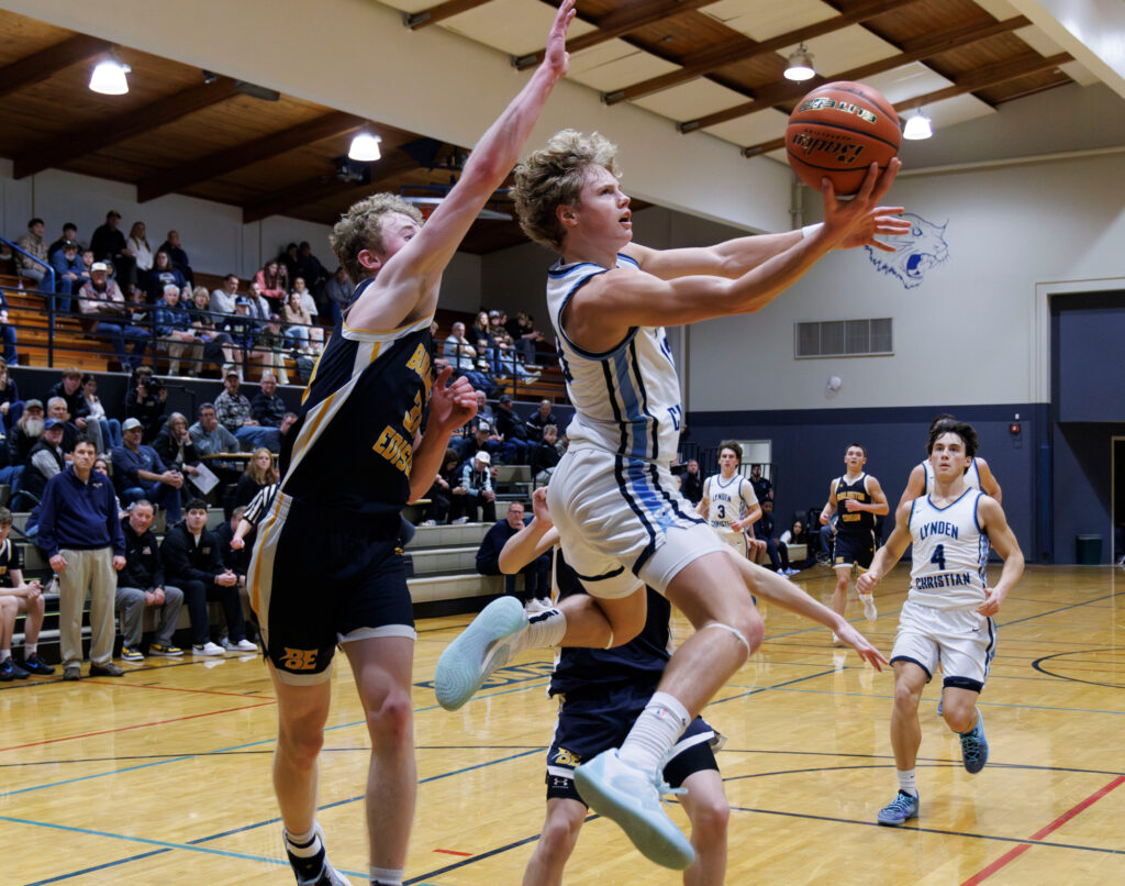 Lynden Christian’s Gannon Dykstra spins and make a layup.