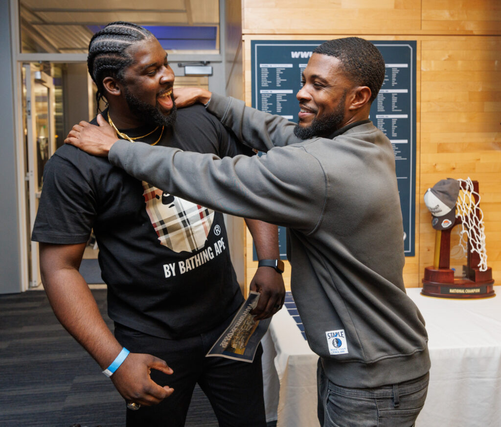 Shedrick Nelson and Rico Williams laugh as they meet before the induction ceremony.