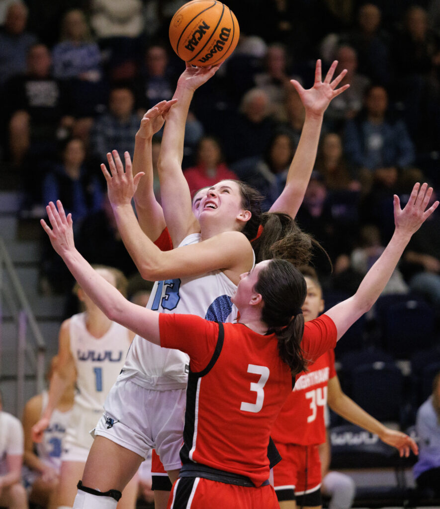 Western's Demi Dykstra drives to the bucket against a Northwest Nazarene double team.