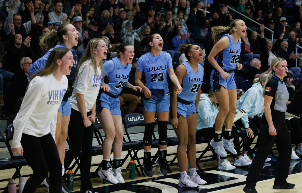 Western players at the bench cheer as they take the lead late in the fourth quarter.