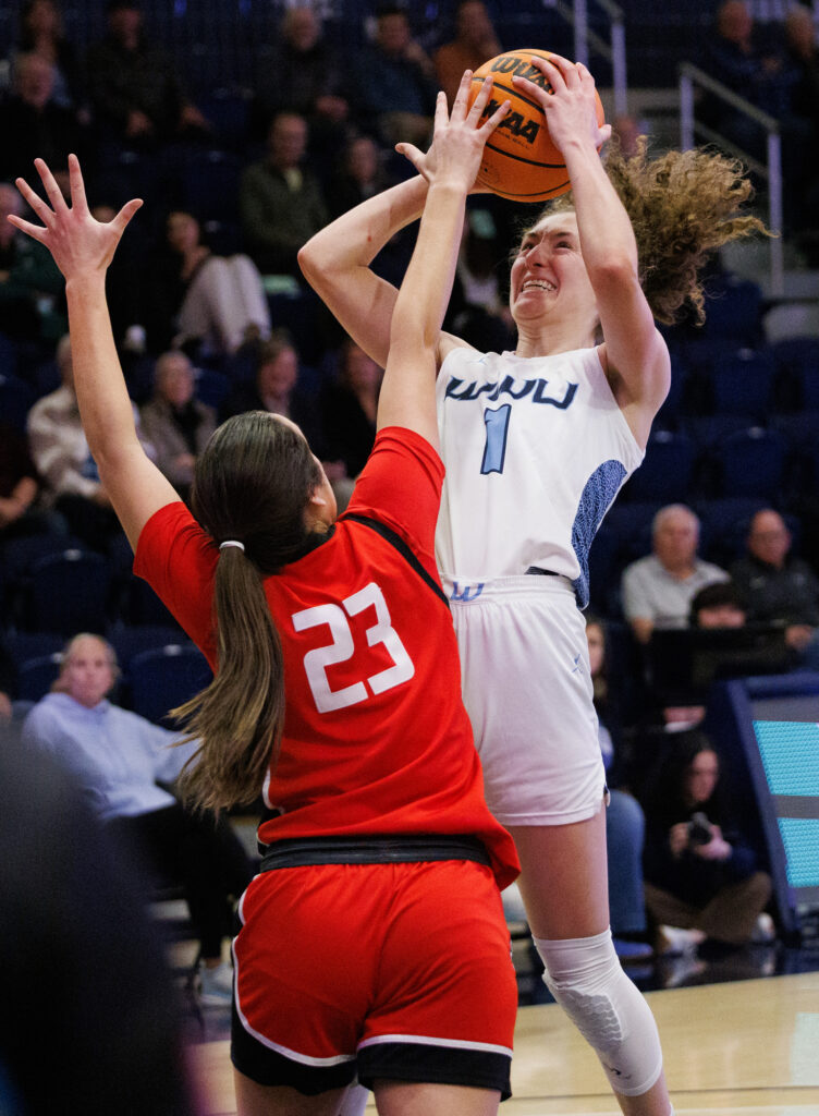 A Northwest Nazarene defender gets a hand on a shot by Western's Olivia Wikstrom.