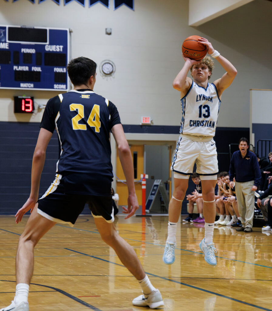 Lynden Christian’s Gannon Dykstra hits a wide-open 3-pointer.