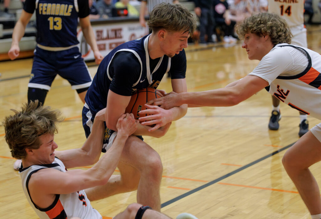 Ferndale’s Hunter Wills fights for the ball against Blaine’s Beckum Bleazard and Jacob Dohner.