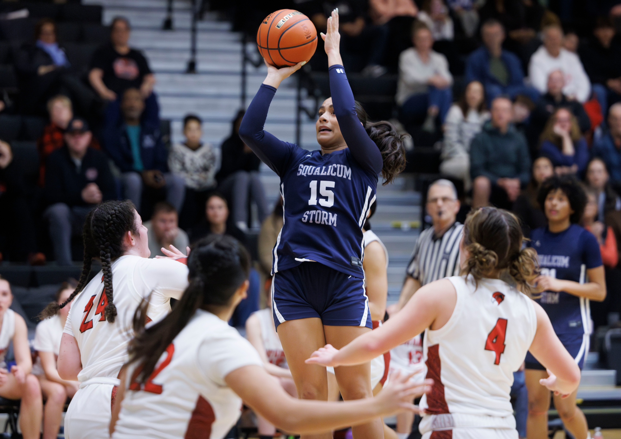 Squalicum’s Jolie’ Paz takes an uncontested jump shot surrounded by Bellingham defenders.