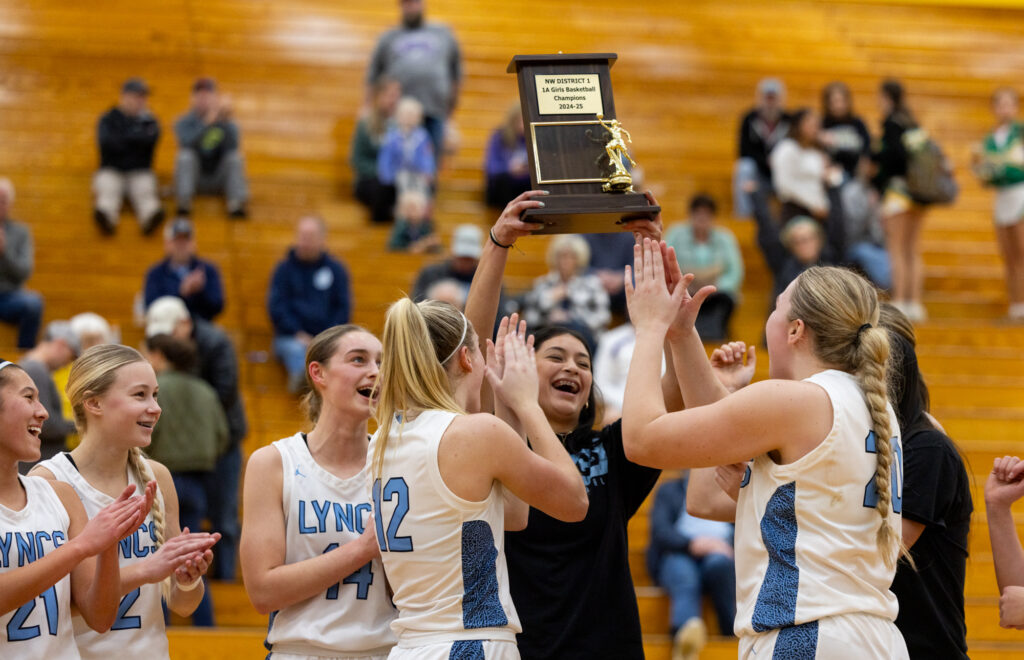 Lynden Christian girls basketball hoists the 1A District 1 championship trophy Feb. 15 after defeating Nooksack Valley 59-30 at Lynden High.