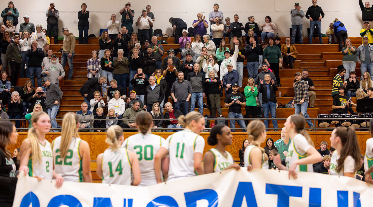 Lynden fans take pictures of the girls team after winning the district title.