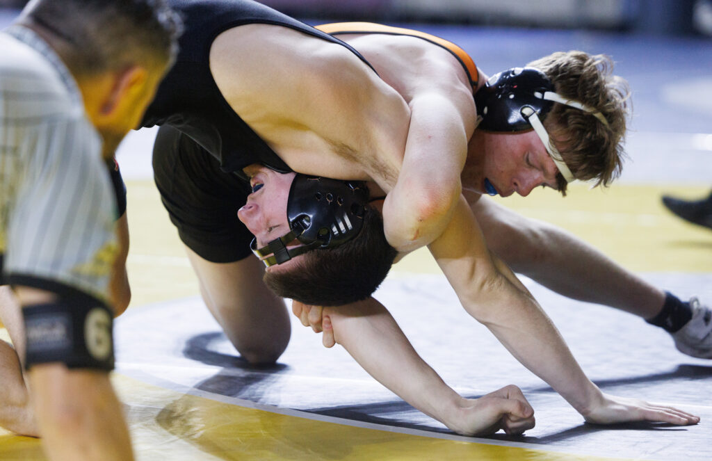 Mount Baker's Wyatt Freeman struggles to get out of the grip of Cashmere’s J. Novak.