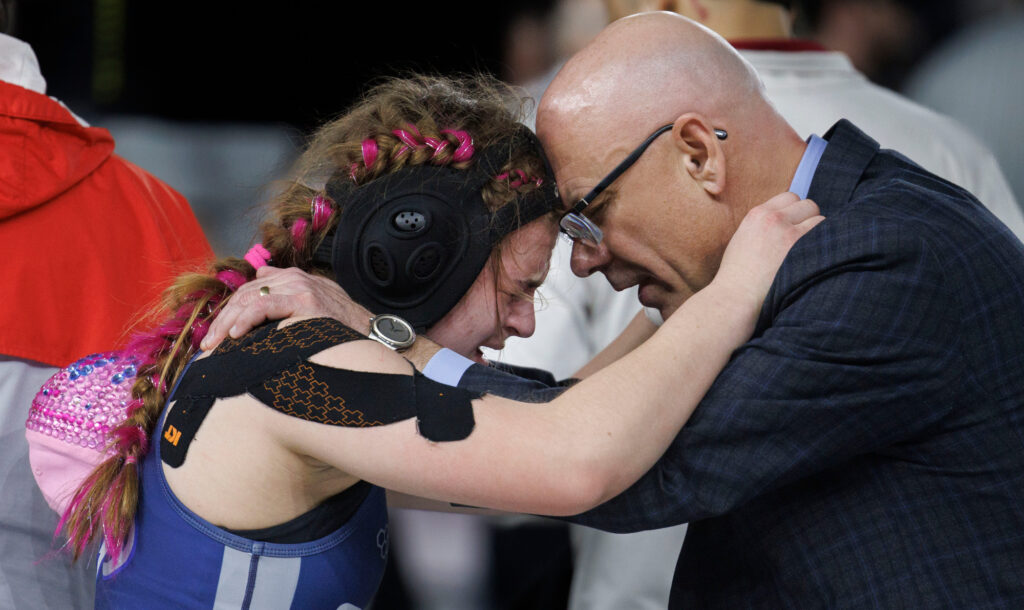 Squalicum’s Claire Hume is consoled by her father Scott Hume Feb. 22 after losing in the 130-pound final during Mat Classic XXXVI held at the Tacoma Dome.