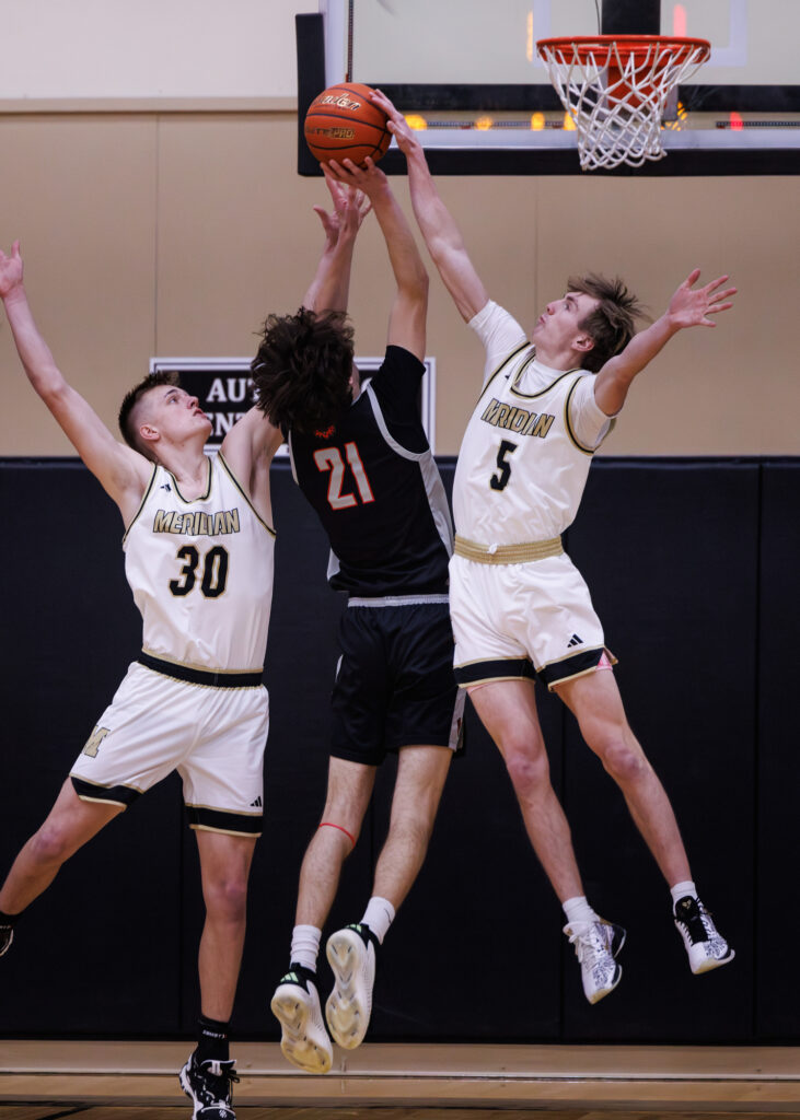 Meridian’s Jaeger Fyfe blocks a shot by Bellingham’s Kincade Vanhouten.