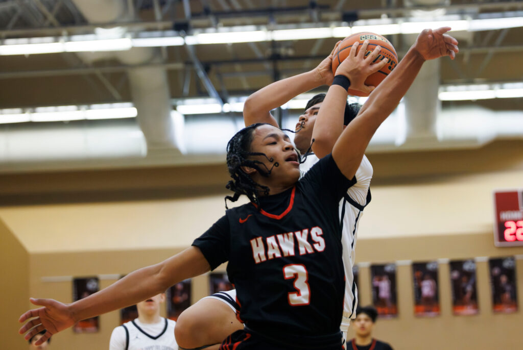 A Tulalip Heritage defender misses the block as Lummi Nation’s Deandre James drives to the hoop.