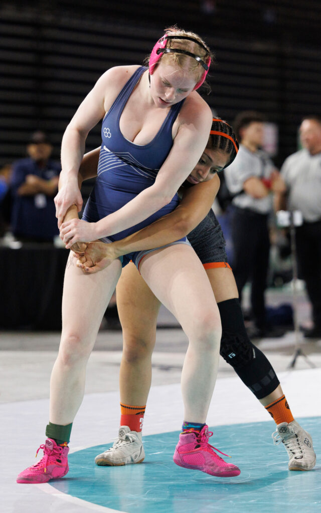 Squalicum's Brooke Legoe  tries for an escape against Washougal’s Aliyha Vargas in the 145-pound title match