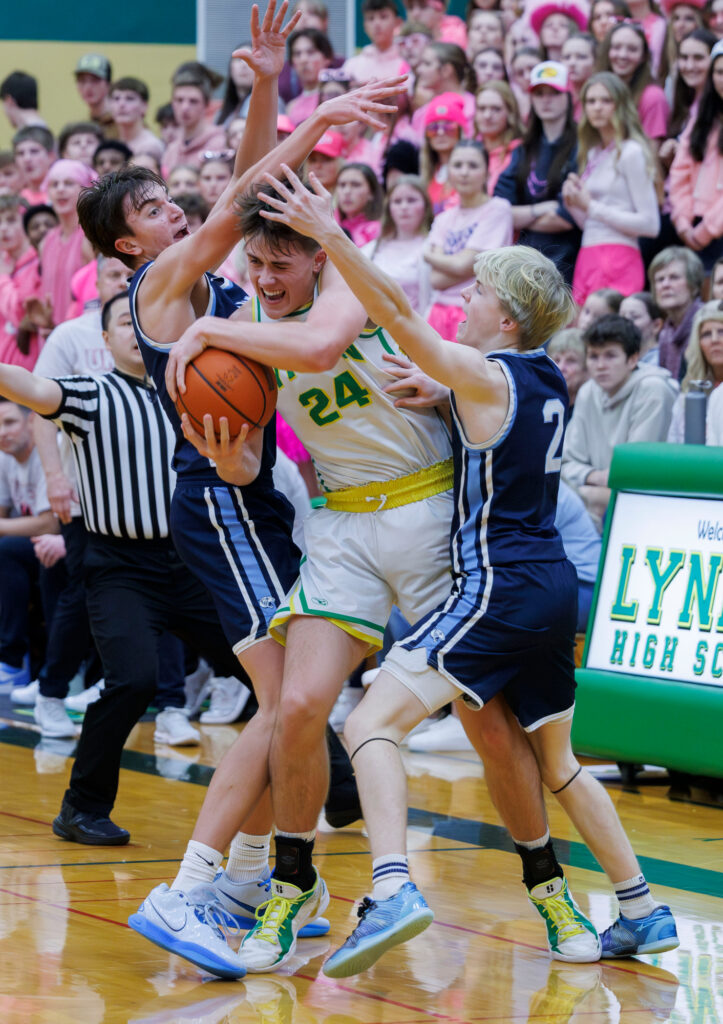 Lynden’s Spencer Adams is guarded hard by Lynden Christian’s Luke VanKooten and Carter Ahlers.