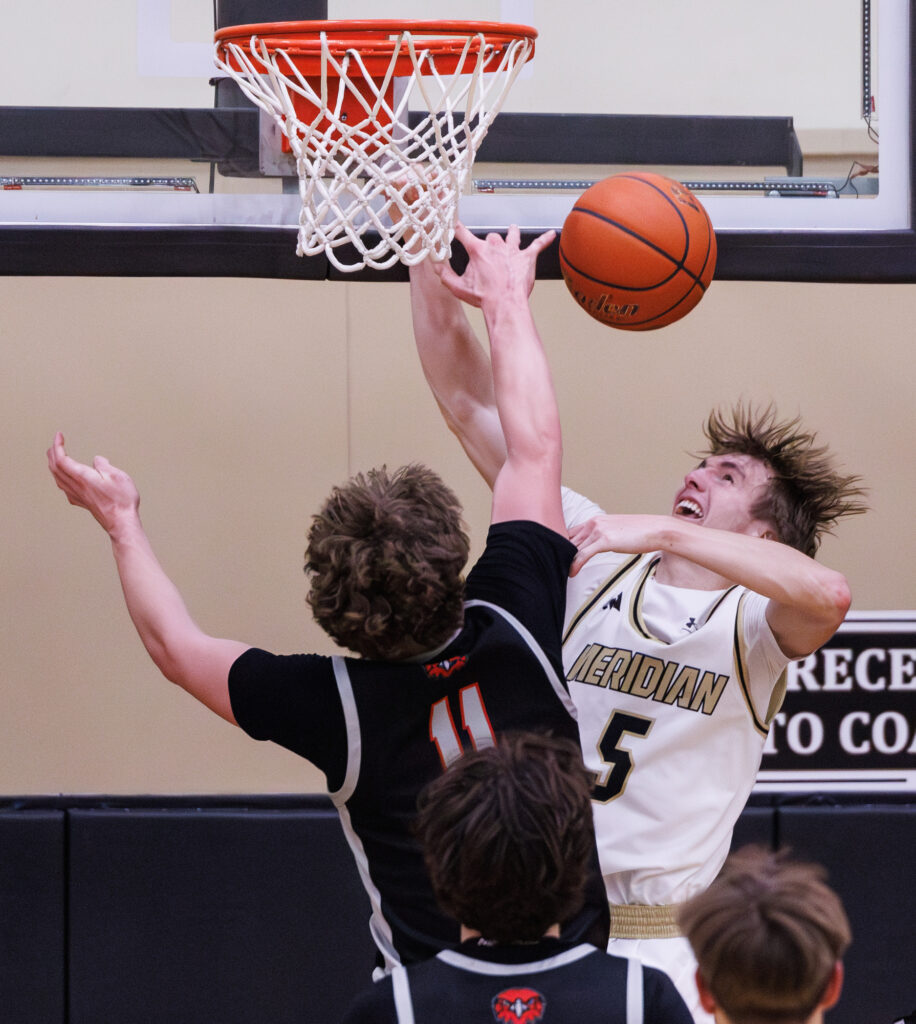 Bellingham’s Joe Harward swats away a shot by Meridian’s Jaeger Fyfe.