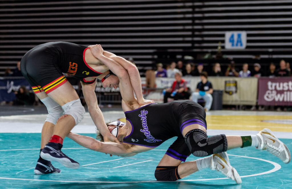 Anacortes’ Talin Kerr shoots for a takedown of Steilacoom’s Jack Lovell in a 2A boys 132-pound match.