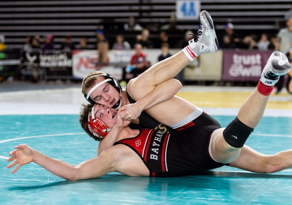 Bellingham’s Nathan Laas tries to fight out of a cradle against North Kitsap’s Wyatt Sloan in the 2A boys 157-pound division.