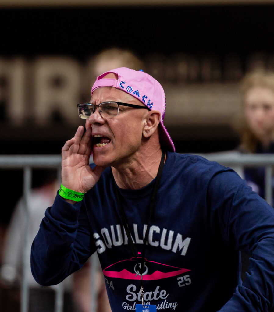 A Squalicum coach shouts instruction to Claire Hume in a 2A girls 130-pound match.