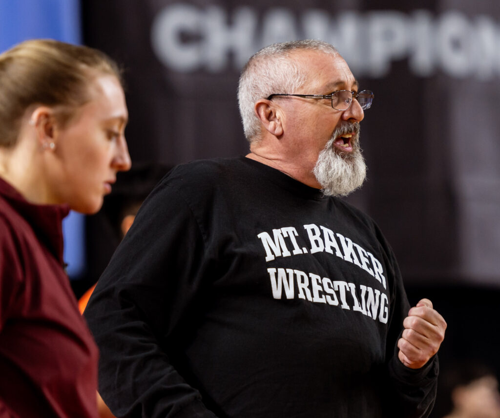 Mount Baker coach Clyde Blockley gives instruction during a blood timeout.