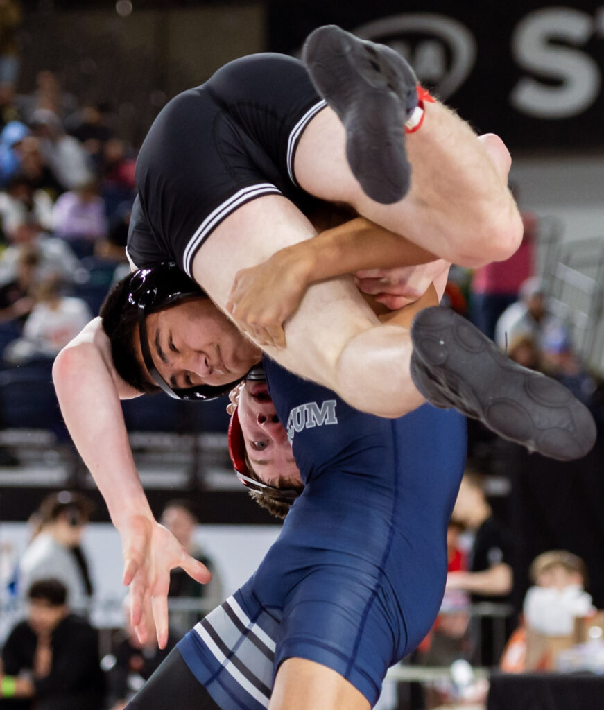 Squalicum’s Thane Hinds lifts Black Hills’ Caleb Stuckert for a throw in a 2A boys 138-pound match.