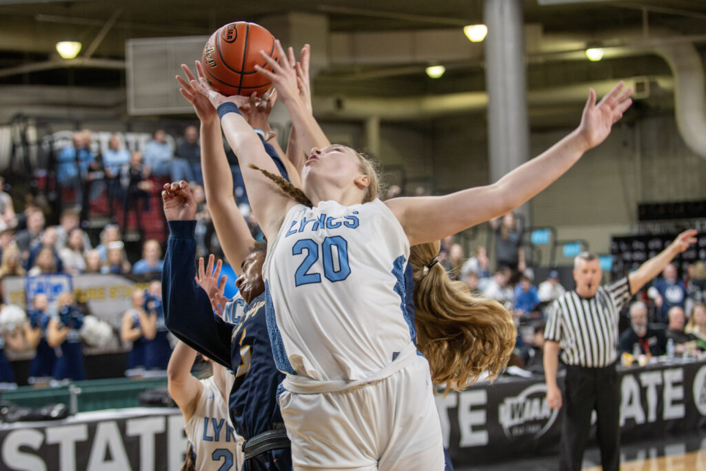 Lynden Christian post Allison Shumate reaches up for a rebound attempt.