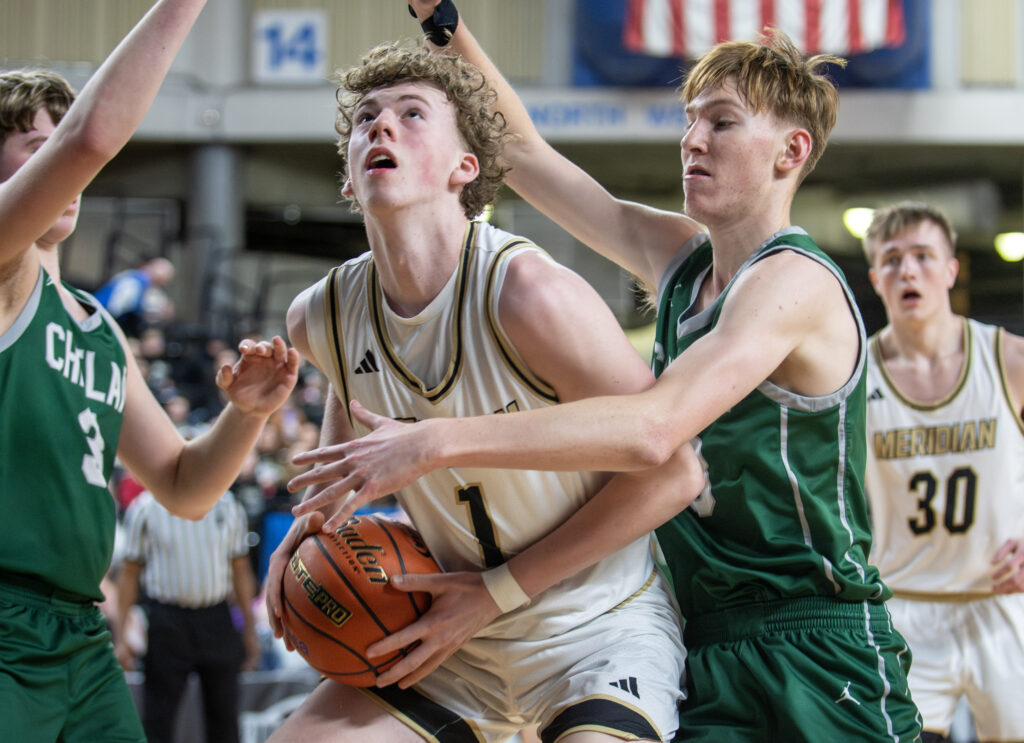 Meridian senior Talon Jenkins looks for an opening in Chelan's defense under the basket.