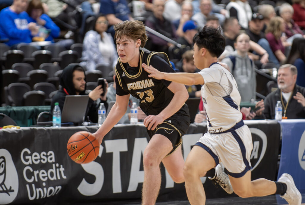 Meridian sophomore point guard Pierce Brzozowski breaks through Seton Catholic's full-court press March 7 during the Trojans' 68-48 win in a loser-out game at the Yakima Valley SunDome. The Trojans clinched a state trophy with the win.