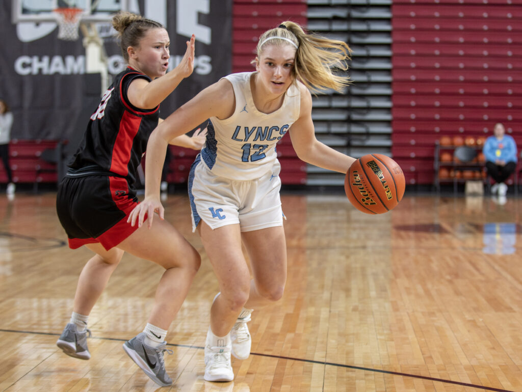 Lynden Christian's Ella Fritts drives around a King's defender.