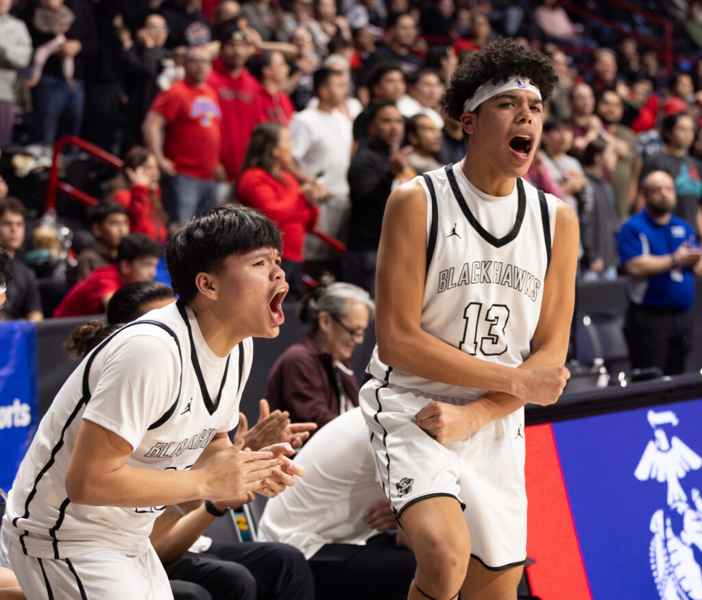 Senior forward Trevon Lee (13) and sophomore forward Gregory Hawk celebrate a late score.