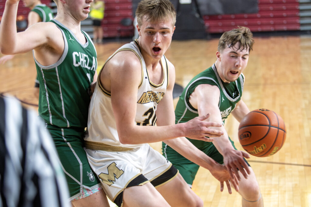 Meridian senior James Hedahl gets the ball smacked away by a Chelan defender.