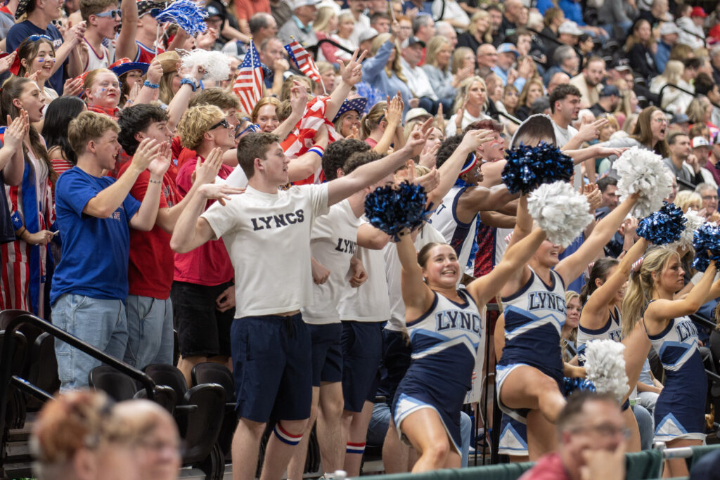 Lynden Christian's student section celebrates after the Lyncs' hit a 3-pointer against Royal.