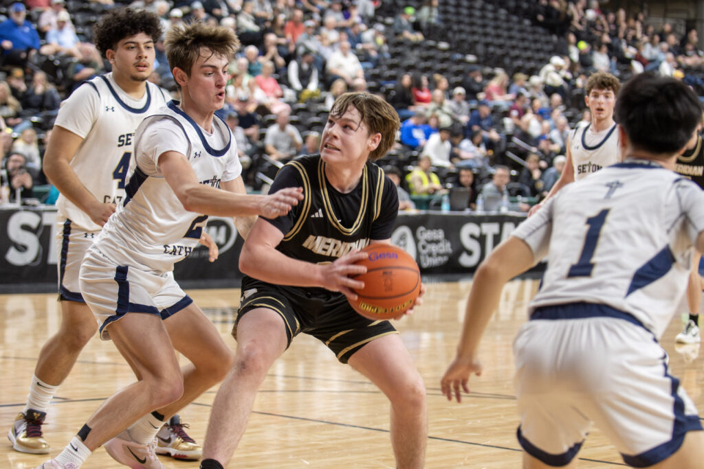 Meridian junior Pierce Brzozowski looks for an open shot in the paint.