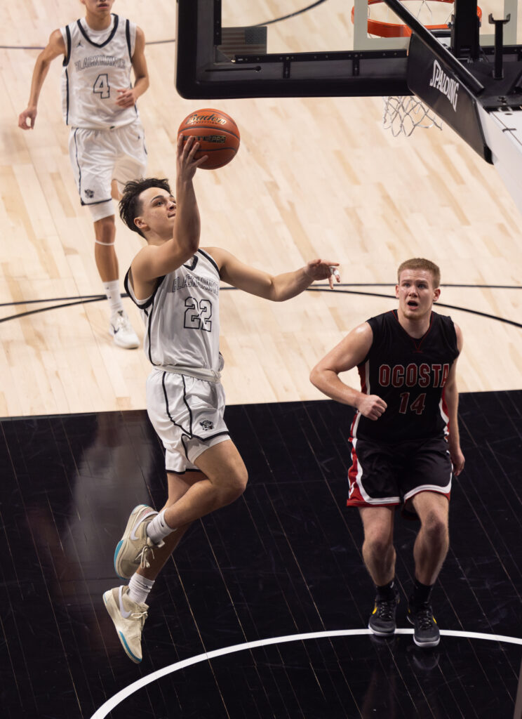 Senior guard Karson Revey scores a fast-break layup.