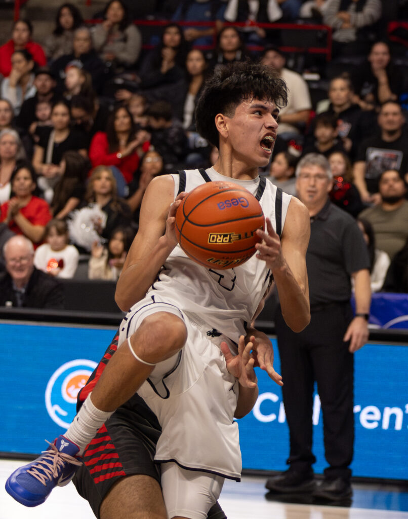 Sophomore guard Dyson Edwards tries to get a shot up as he's fouled.