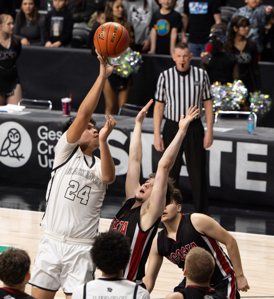 Sophomore center Deandre James hooks the ball over a defender.