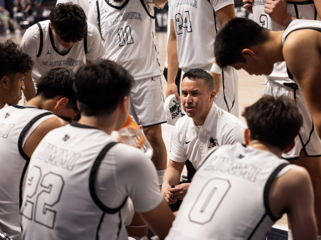 Lummi Nation head coach Jerome Toby talks to the team after the third quarter.