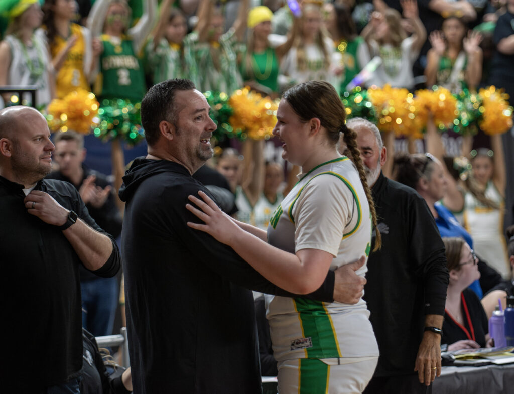 Lynden head coach Rob Adams and junior Payton Mills hug after beating Ellensburg in the state title game for the second straight season.