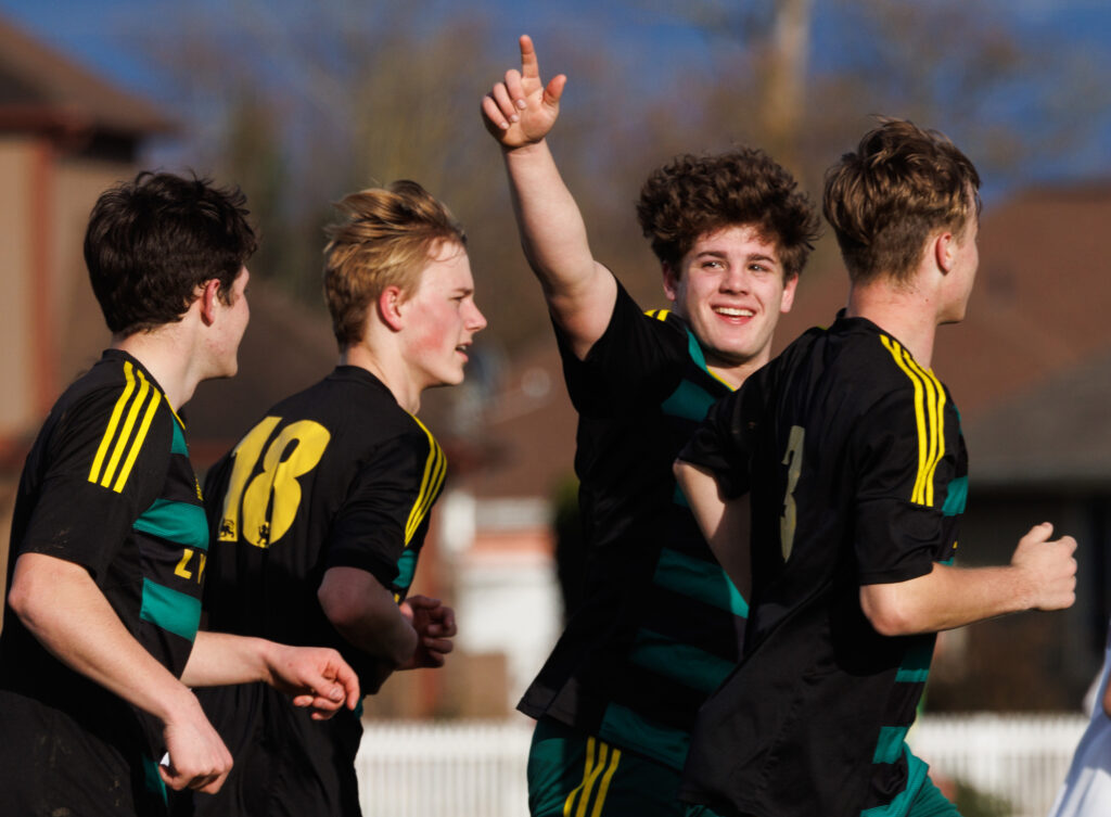 Lynden’s Malachi Koenen points to the fans March 18 after scoring a goal as the Lions beat Lakewood, 4-0, at Bender Fields in Lynden.