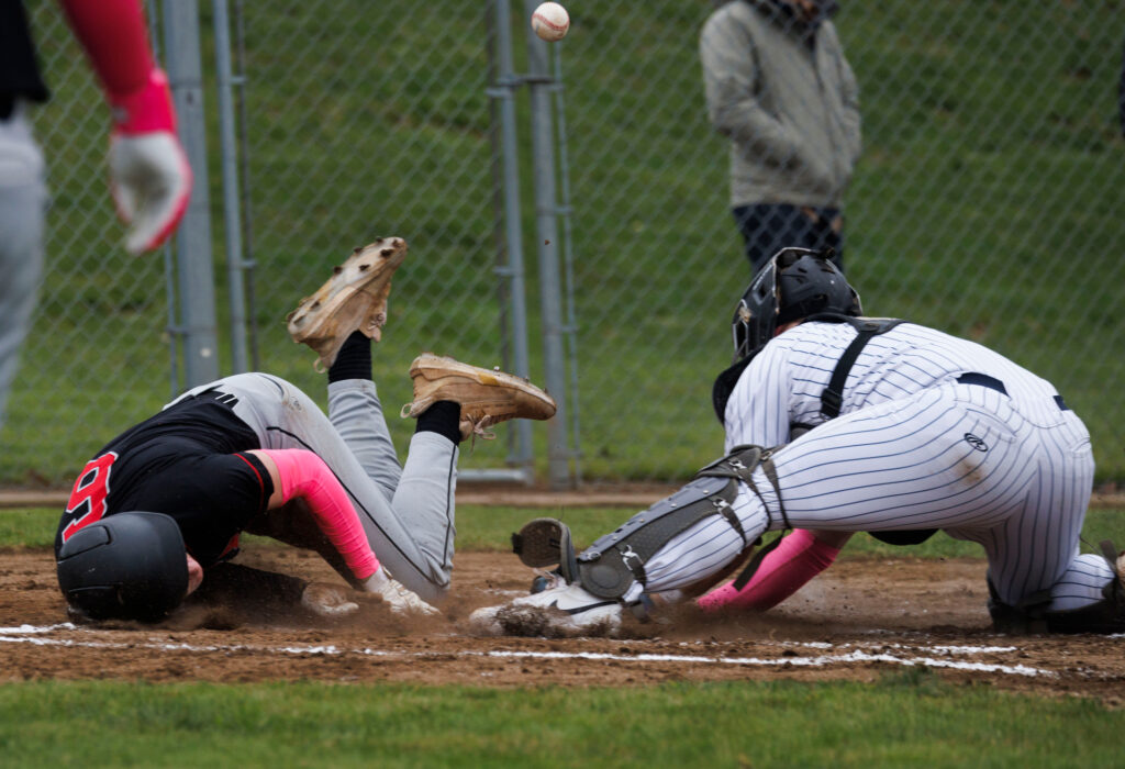 Mount Baker’s Kaden Mosher rolls over his head while sliding in for the Mountaineers' only run on the day.