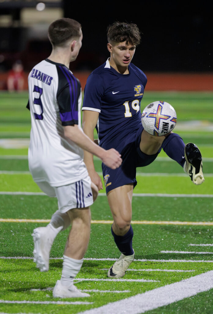 Ferndale's Max Savchak kicks the ball back over the head of Anacortes’ Jackson Eckhardt.