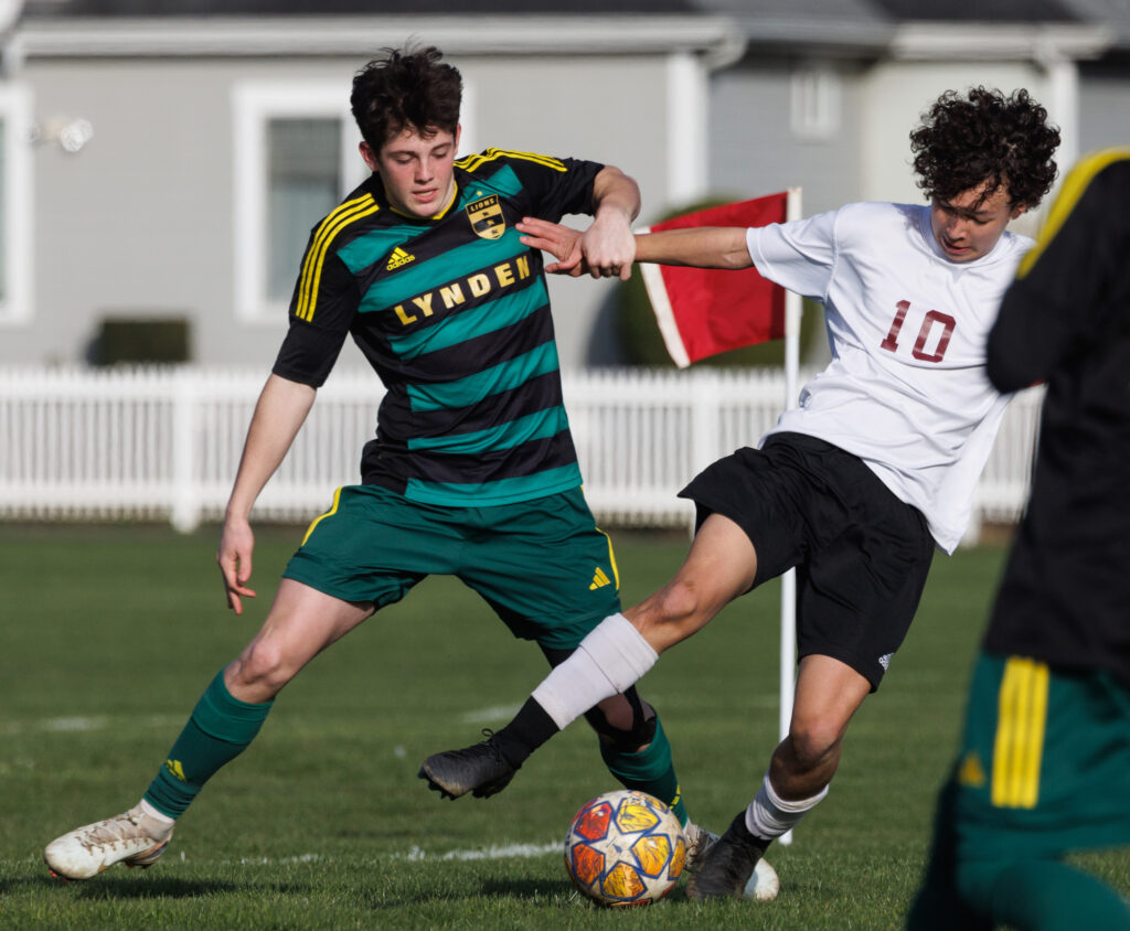 Lynden’s Markus Koenen grabs a Lakewood defender while keeping the ball in play.