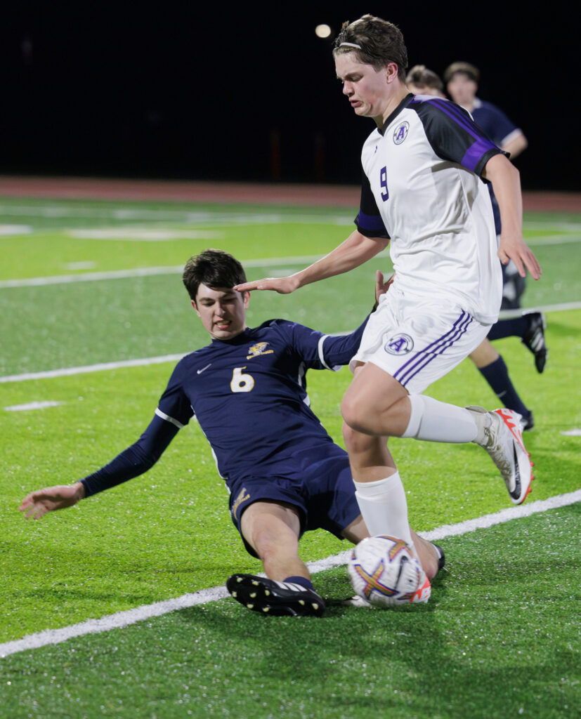 Ferndale's Alexey Odushkin makes a sliding tackle against Anacortes’ Victor White.